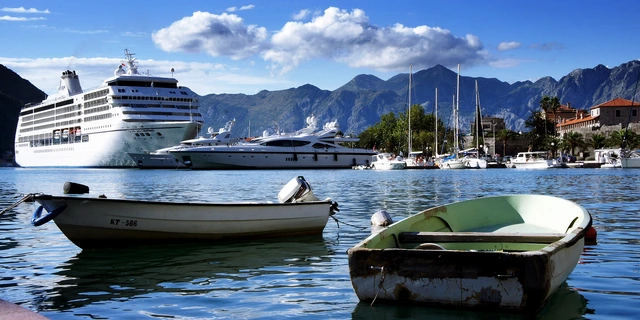 Cruise Ship Seven Seas Mariner in a harbour with some fishing boats in the foreground